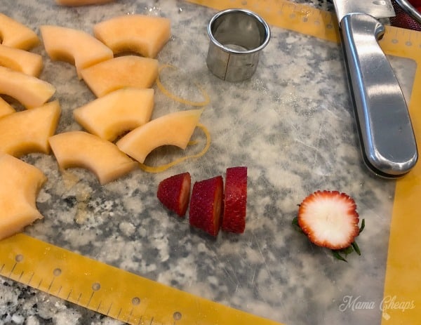 slicing strawberries cantaloupe
